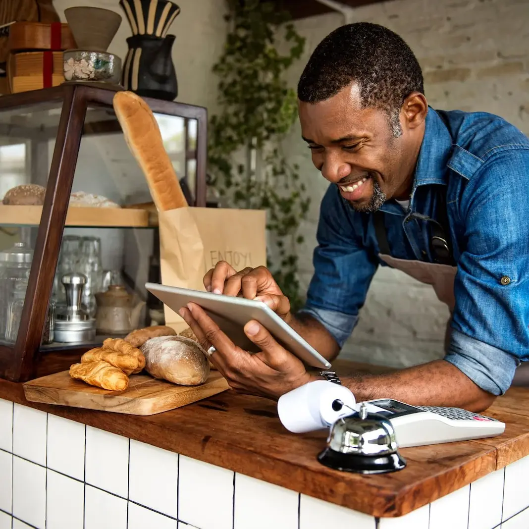 man looking at ipad at bakery