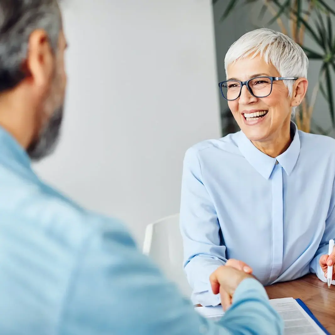 woman shaking hands with man